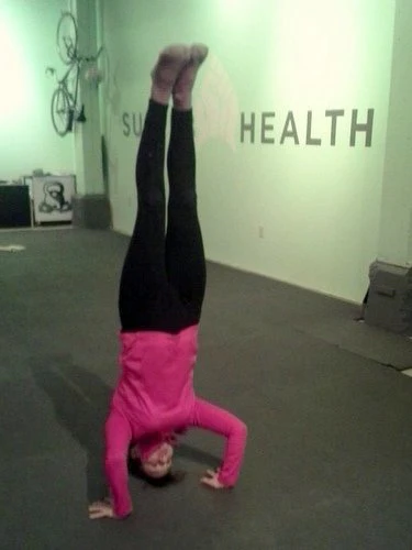 Natalie Lynch getting her first headstand post-pregnancy after weeks of failed attempts