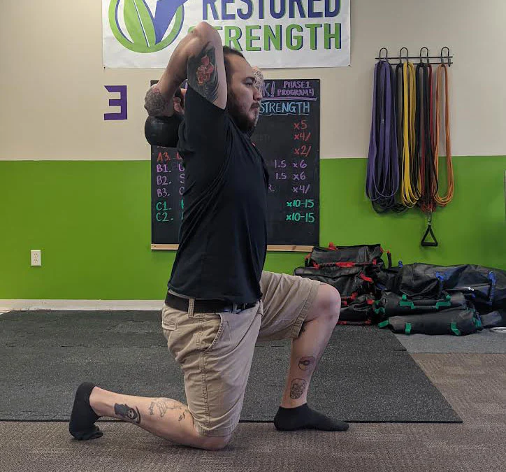 William Sturgeon performs a half kneeling kettlebell halo
