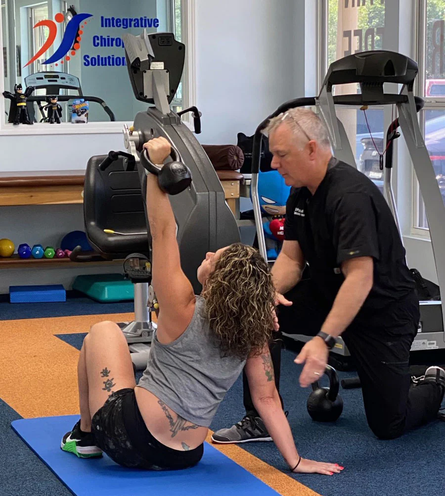 Paul Britt instructing an athlete performing a get-up