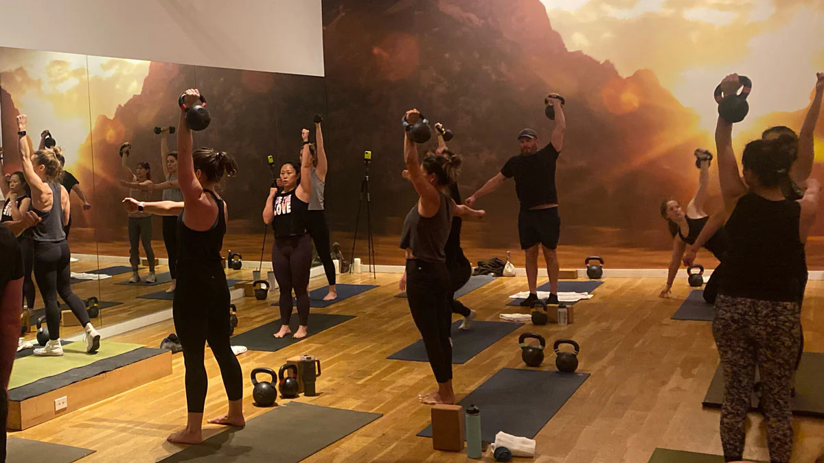 Rebecca Codi leading a group with kettlebell get-ups
